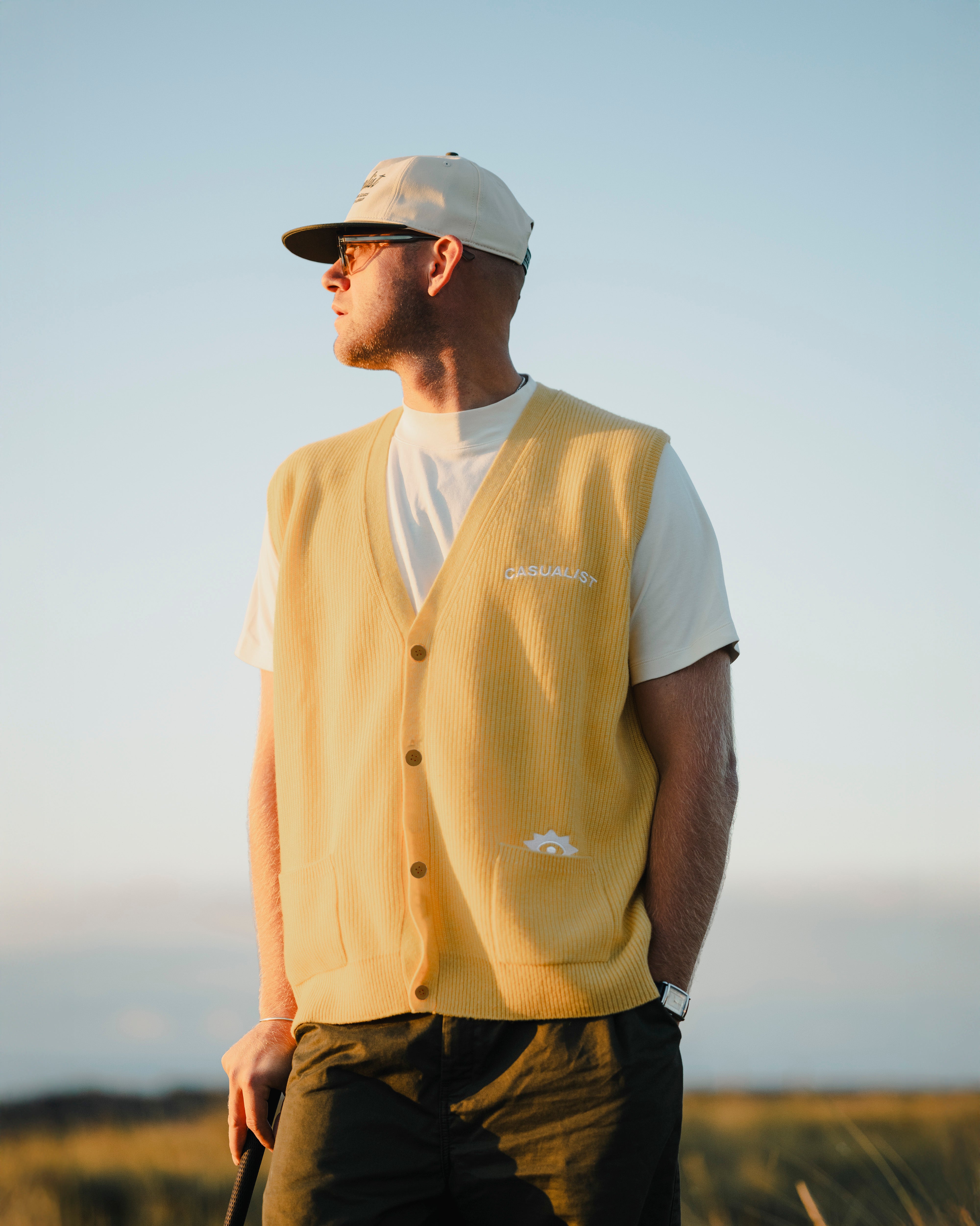 Grazer Cardigan Vest worn on course yellow Casualist lifestyle